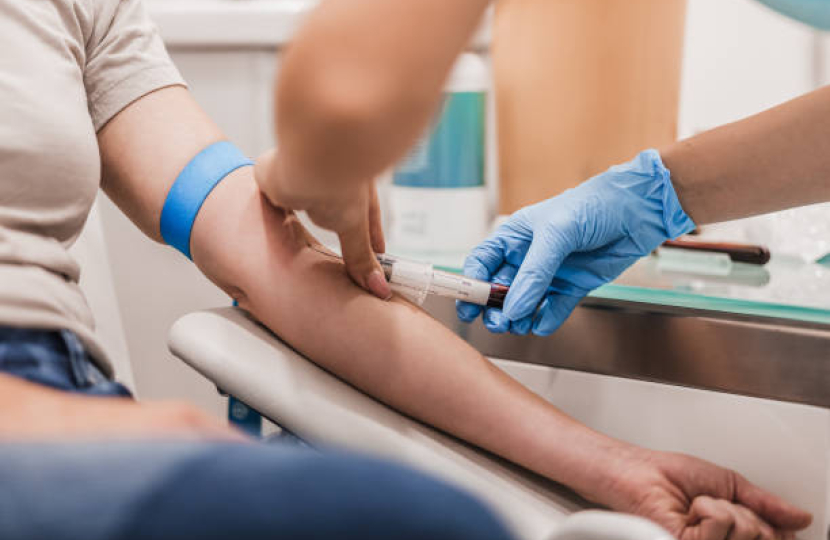 Close up of person donating blood in a hospital setting 