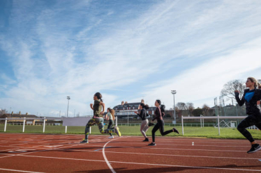 People running on athletics track