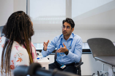 GP talking to patient in a treatment room 